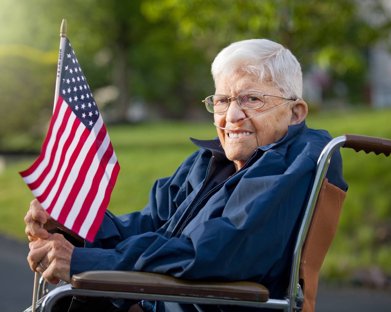 Veterans Service in Wheel chair holding an American Flag